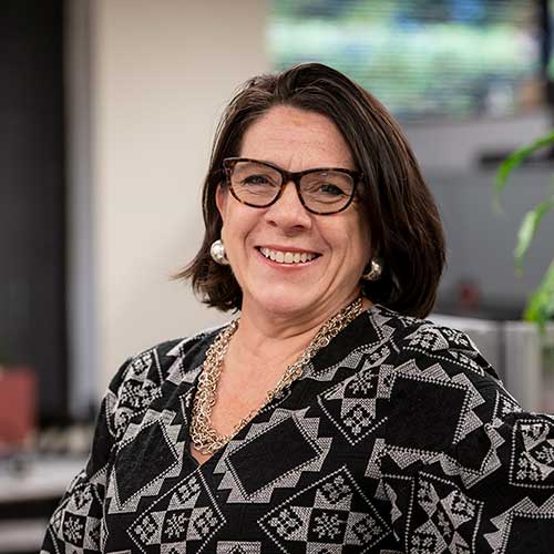 Smiling woman poses in an office